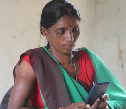 Reach Mobile - A recipient of free connectivity, Mary watches farming videos on YouTube for her crops.